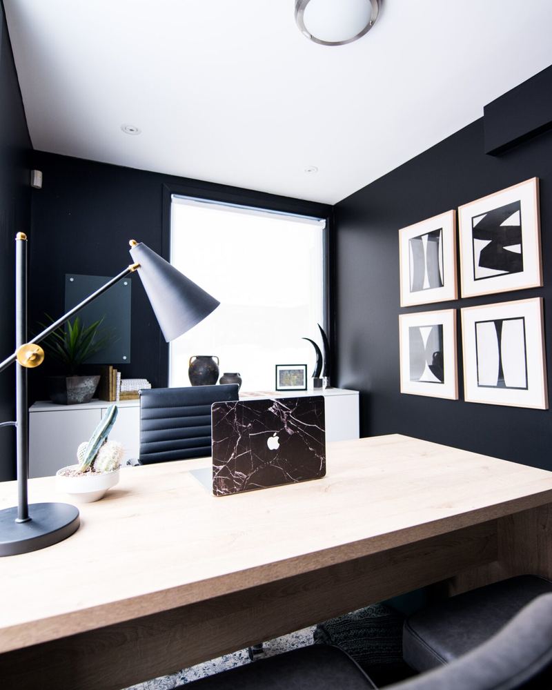 Werkplek met een houten bureau bij het raam